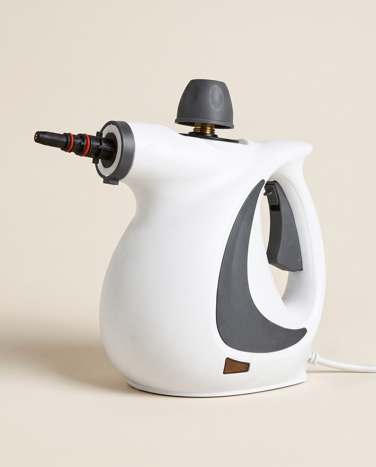White and grey handheld steam cleaner with trigger handle, safety cap and black steam nozzle